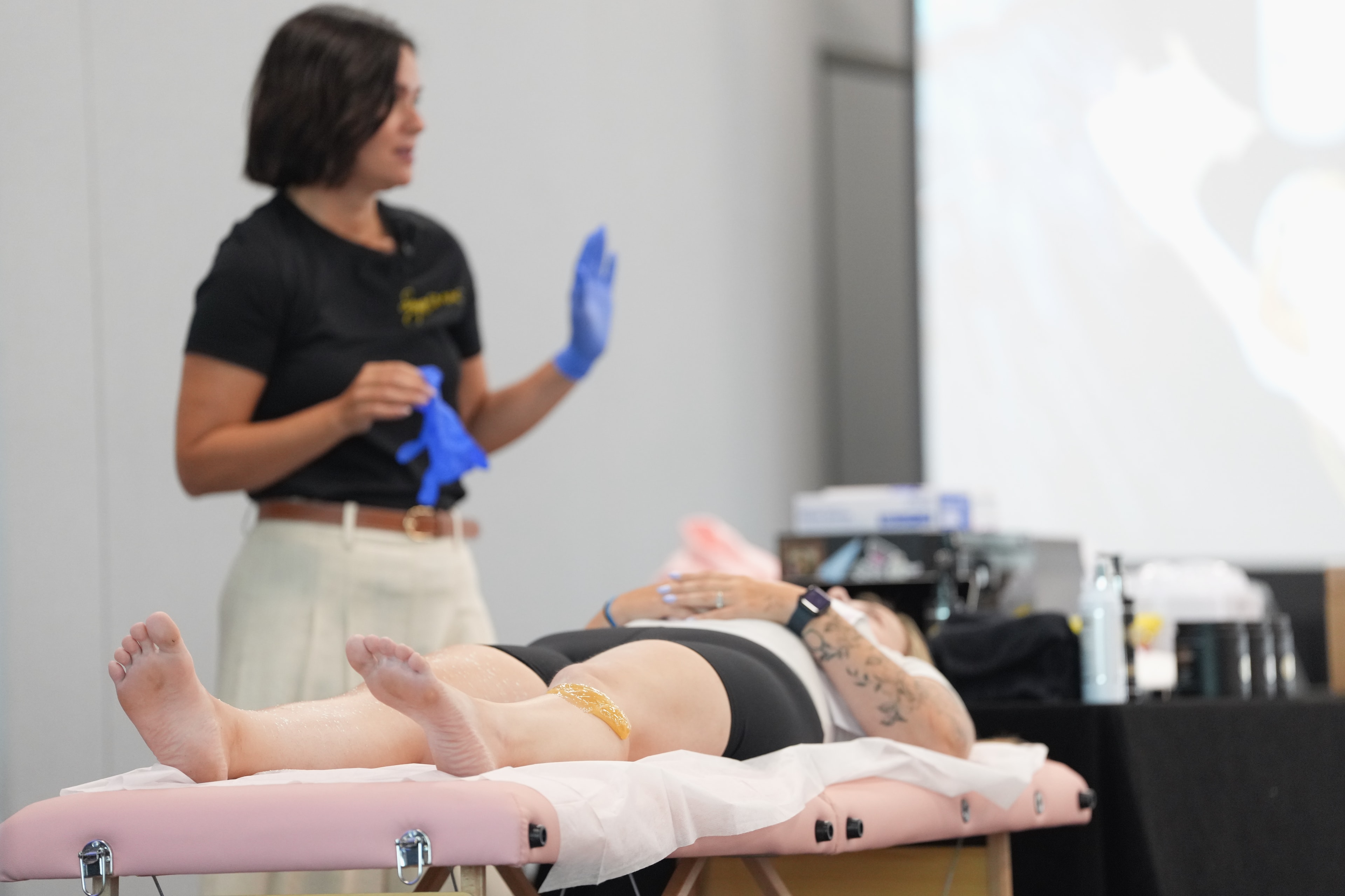 Educator performing a hands-on sugaring demonstration for attendees